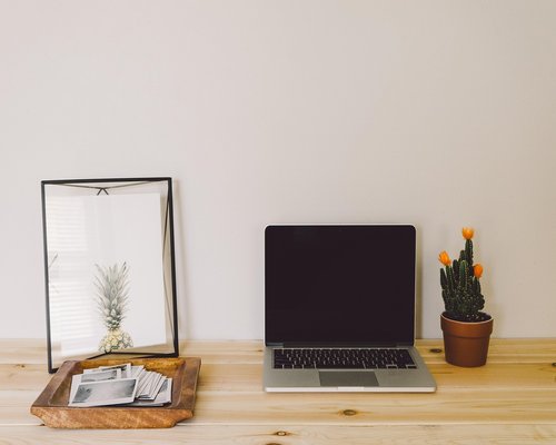 Organized and comfortable home office desk setup with good lighting